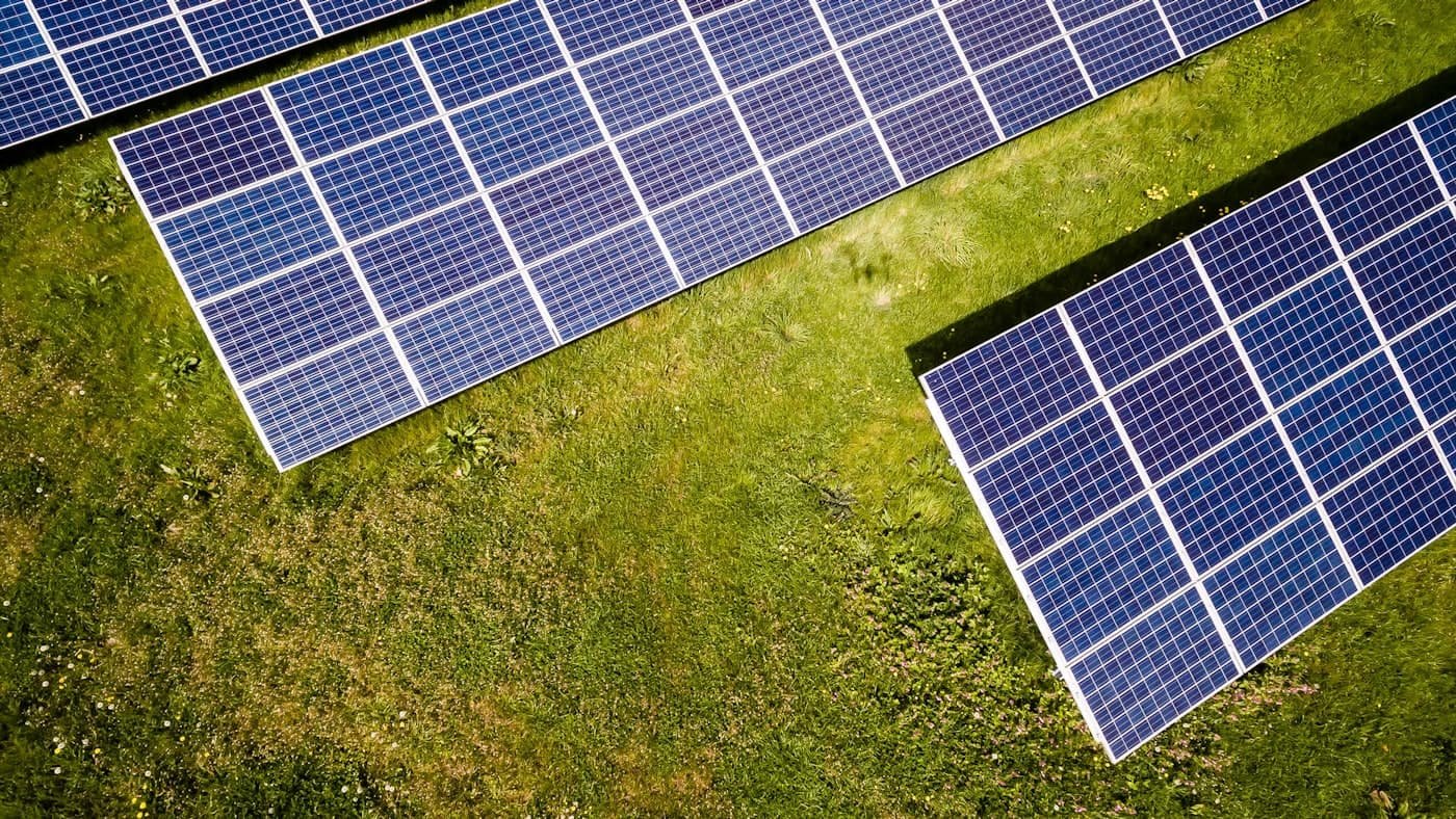 Ground-mounted solar panels on a grass field