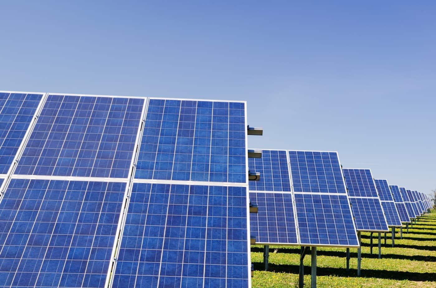 Rows of solar panels under a clear blue sky