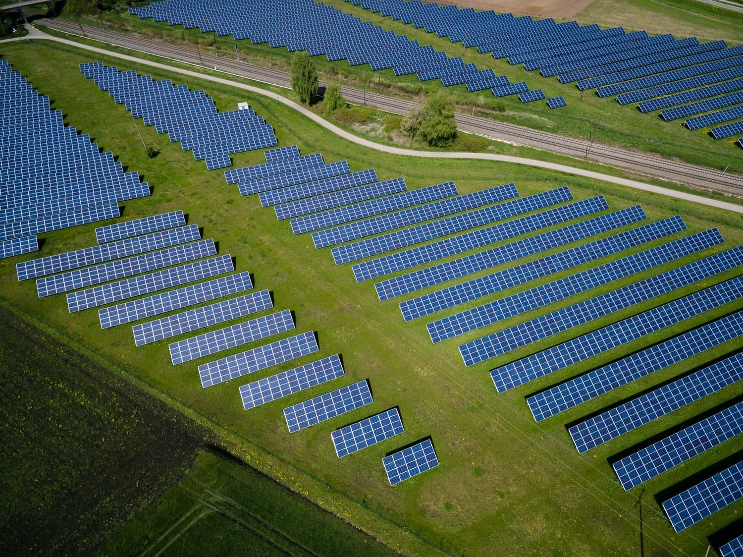 An aerial view of long rows of solar panels